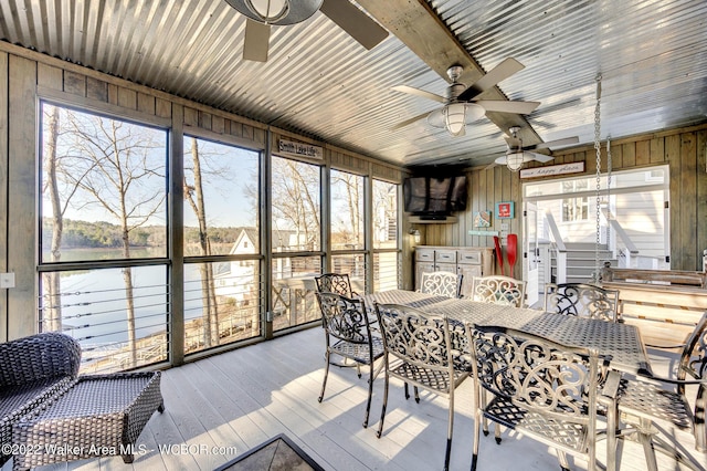 sunroom with a wealth of natural light and ceiling fan