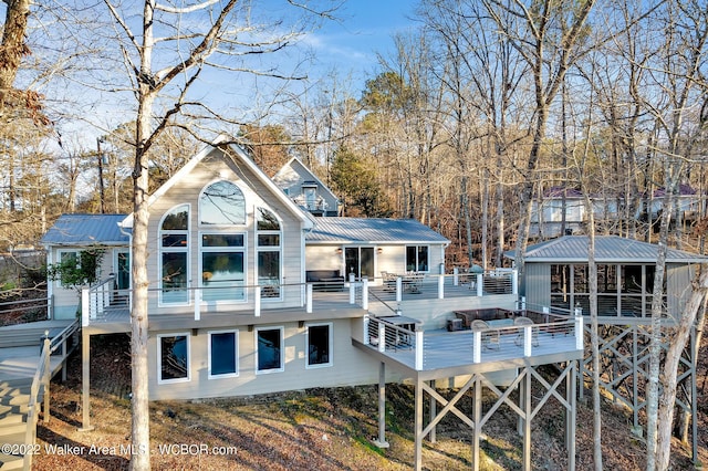 back of house with a wooden deck