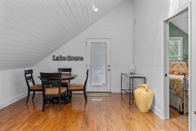 dining area featuring light wood-type flooring, vaulted ceiling, and wood ceiling