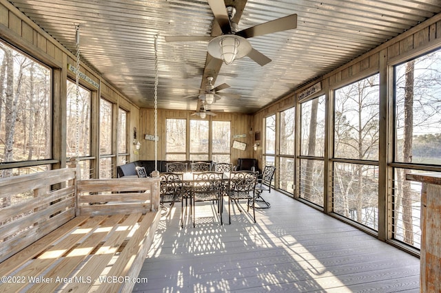 unfurnished sunroom with plenty of natural light, ceiling fan, and wood ceiling