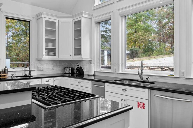 kitchen featuring white cabinetry, a healthy amount of sunlight, and gas stovetop