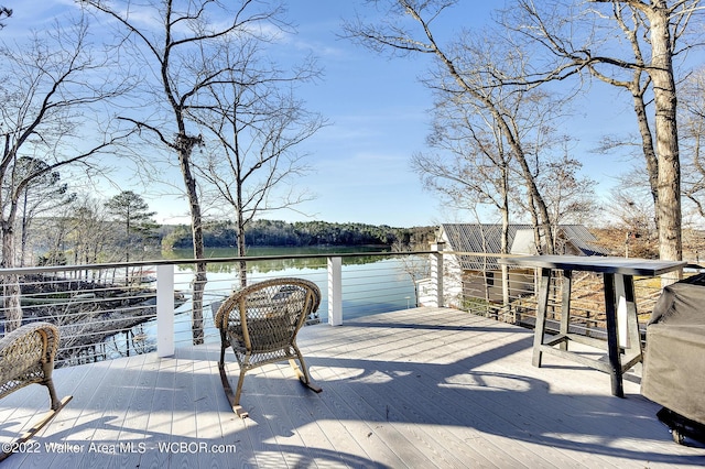 wooden terrace featuring a water view