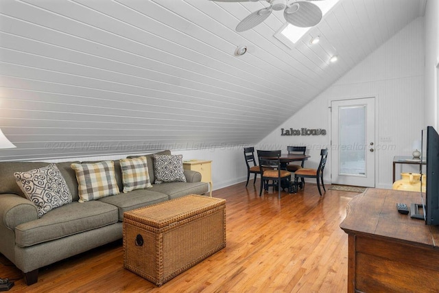 living room with hardwood / wood-style flooring, ceiling fan, lofted ceiling, and wood ceiling