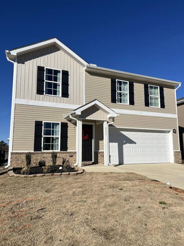 view of front of home with a front yard and a garage