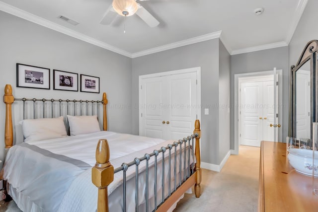 carpeted bedroom featuring a closet, ceiling fan, and crown molding