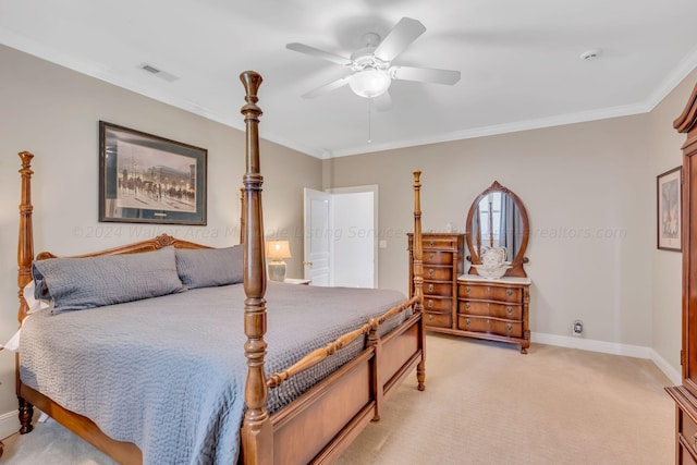 carpeted bedroom featuring ceiling fan and crown molding