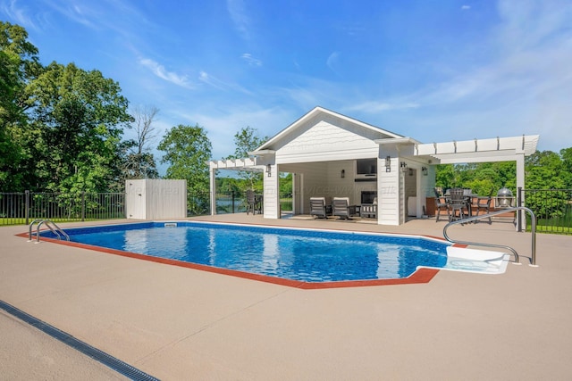 view of pool featuring a pergola, a patio, and an outdoor structure