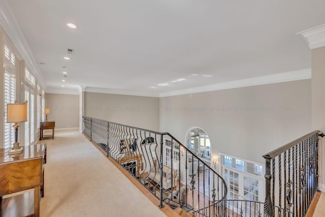 hall with crown molding and light carpet