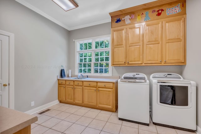 laundry area featuring washer and dryer, light tile patterned flooring, cabinets, and crown molding