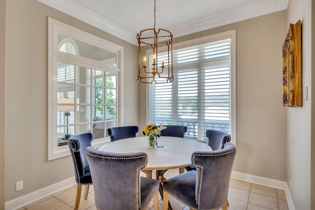 dining space with light tile patterned floors, ornamental molding, and a chandelier