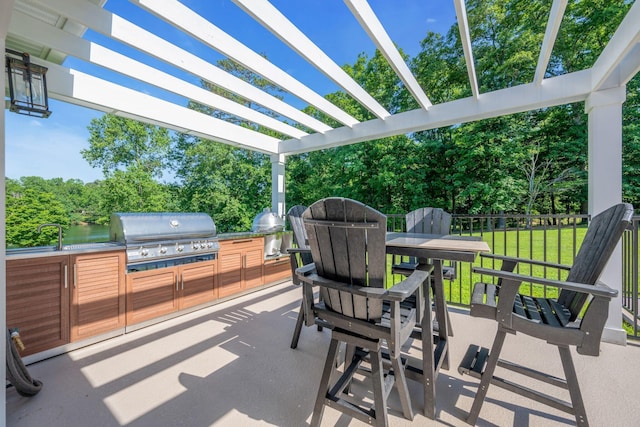 view of patio / terrace featuring a pergola, area for grilling, grilling area, and sink