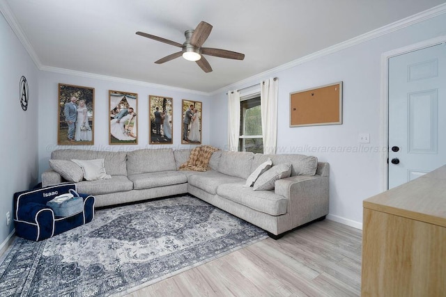 living room featuring crown molding, ceiling fan, and light hardwood / wood-style flooring