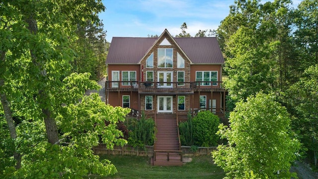 back of house with french doors and a yard