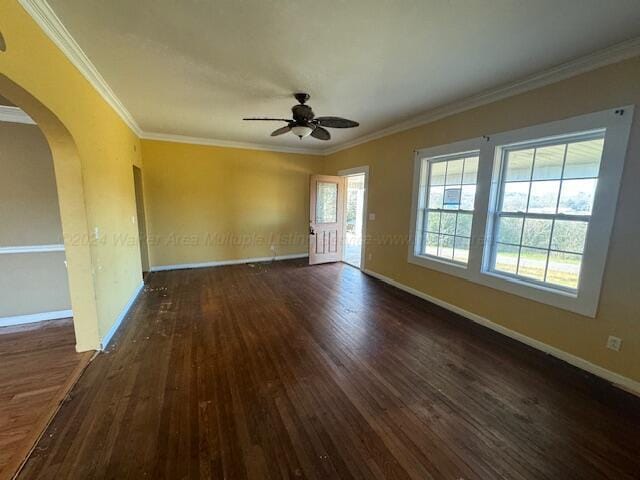 empty room featuring ceiling fan, dark hardwood / wood-style flooring, and ornamental molding