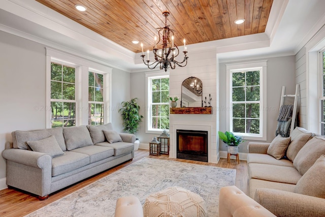 living room with ornamental molding, a raised ceiling, and wood ceiling