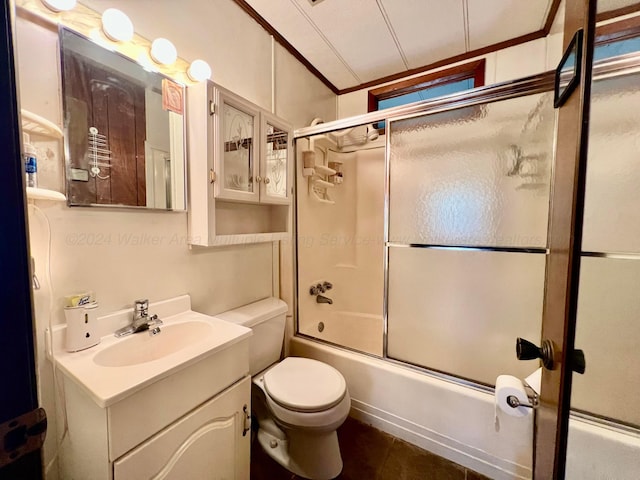 full bathroom featuring vanity, bath / shower combo with glass door, and toilet