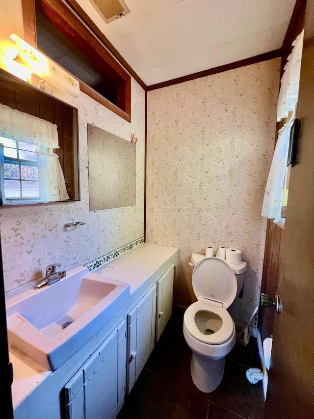 bathroom featuring tile patterned floors, vanity, toilet, and ornamental molding