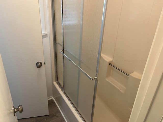 full bathroom featuring wood finished floors and enclosed tub / shower combo