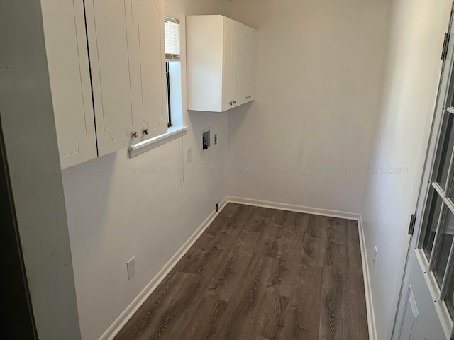 laundry room featuring washer hookup, dark wood-style floors, cabinet space, and baseboards