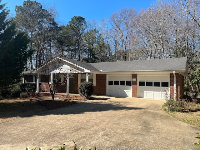 ranch-style home featuring an attached garage, brick siding, and driveway