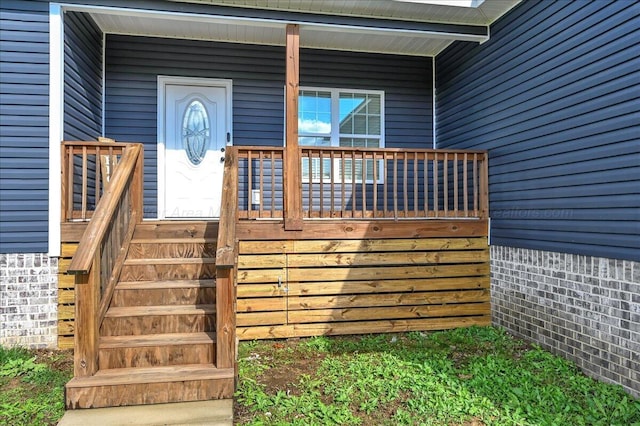 view of exterior entry featuring covered porch