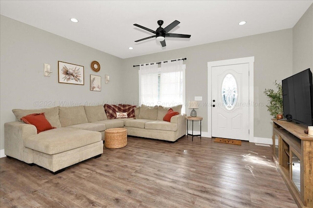 living room featuring hardwood / wood-style flooring and ceiling fan