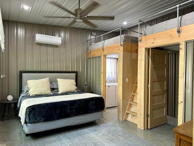 bedroom with an AC wall unit, washer / clothes dryer, wooden walls, concrete floors, and ceiling fan