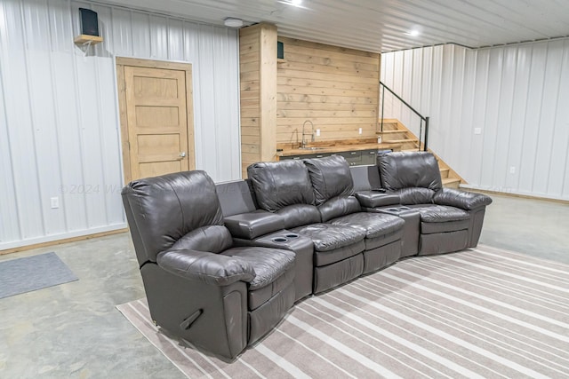 home theater featuring wood walls and wet bar