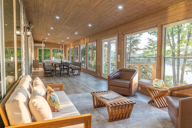 sunroom / solarium with wooden ceiling, a wall unit AC, and vaulted ceiling