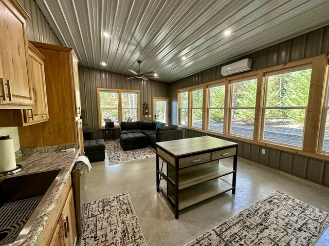 interior space with sink, ceiling fan, and an AC wall unit