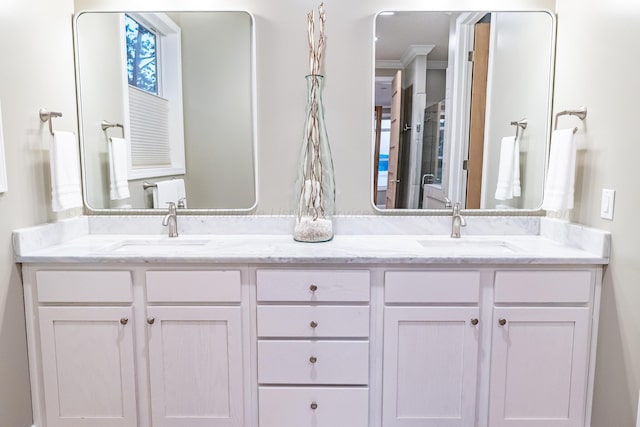 bathroom with vanity and ornamental molding