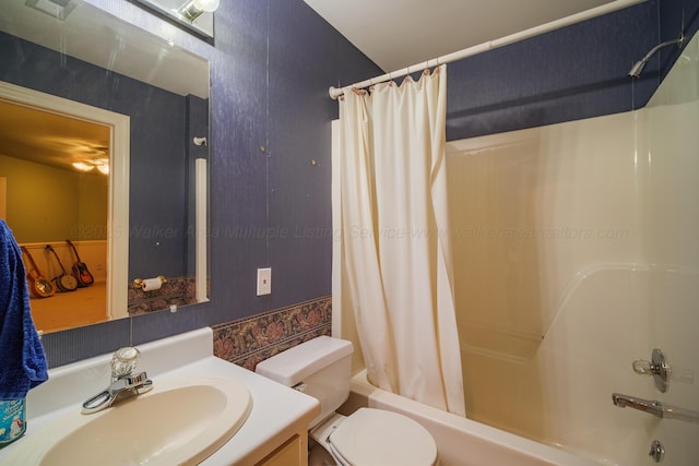 full bathroom featuring shower / tub combo, vanity, and toilet