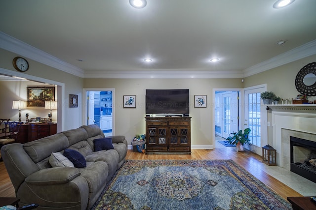 living room with light hardwood / wood-style floors and ornamental molding