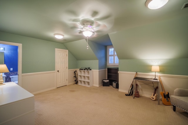 additional living space with ceiling fan, light colored carpet, and lofted ceiling