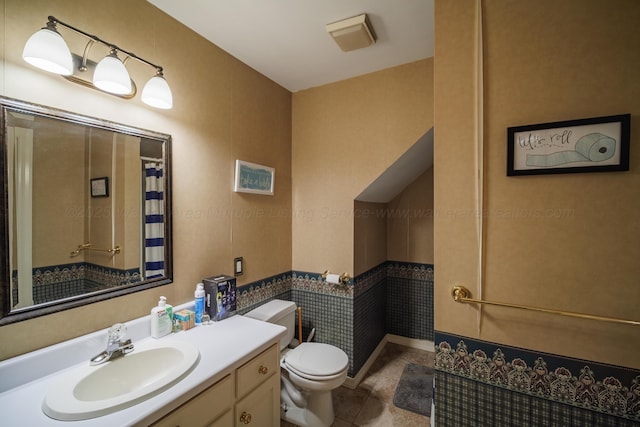 bathroom with tile patterned floors, vanity, and toilet