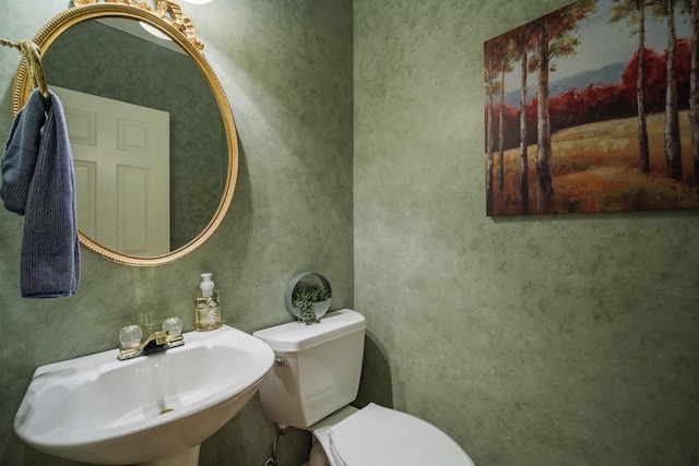 bathroom with toilet and sink