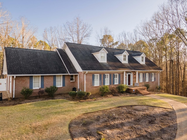 cape cod-style house with a front lawn