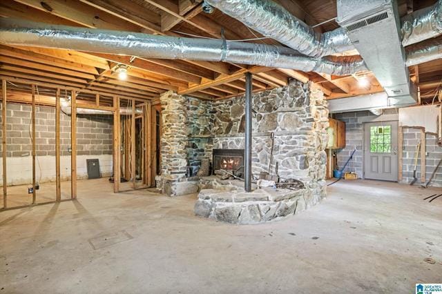 basement with a stone fireplace