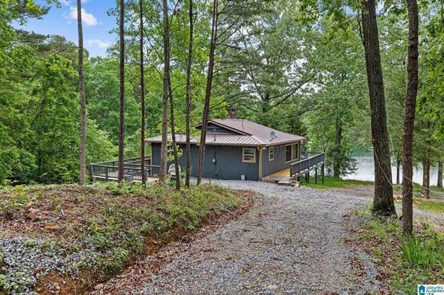 view of side of home with a deck with water view