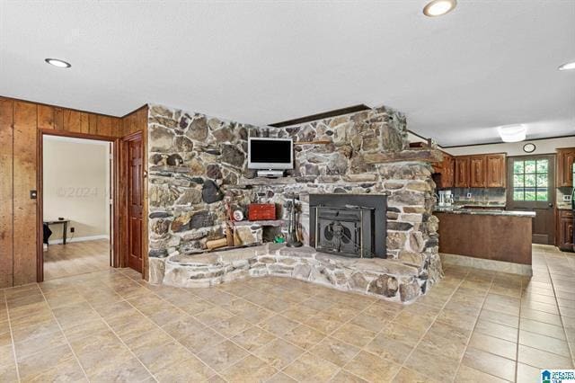 living room with wood walls and light tile patterned flooring