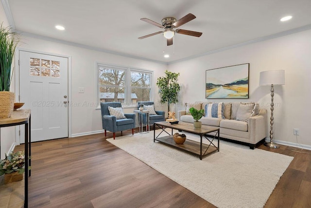 living area featuring baseboards, dark wood-style flooring, and ornamental molding