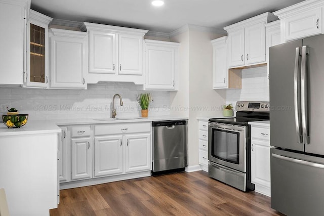 kitchen featuring a sink, dark wood finished floors, appliances with stainless steel finishes, white cabinets, and light countertops