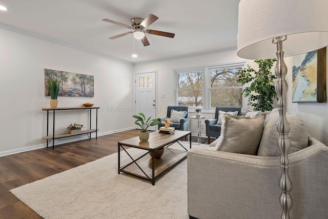 living room featuring recessed lighting, ornamental molding, baseboards, and wood finished floors