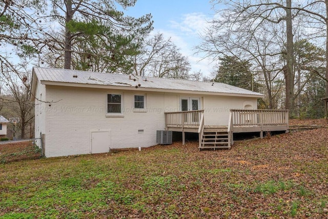 back of property featuring french doors, metal roof, a wooden deck, crawl space, and brick siding