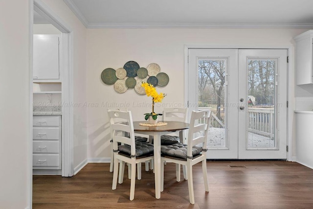 dining space with visible vents, crown molding, baseboards, french doors, and dark wood-style flooring