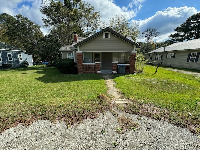 bungalow-style home featuring a front lawn and a porch