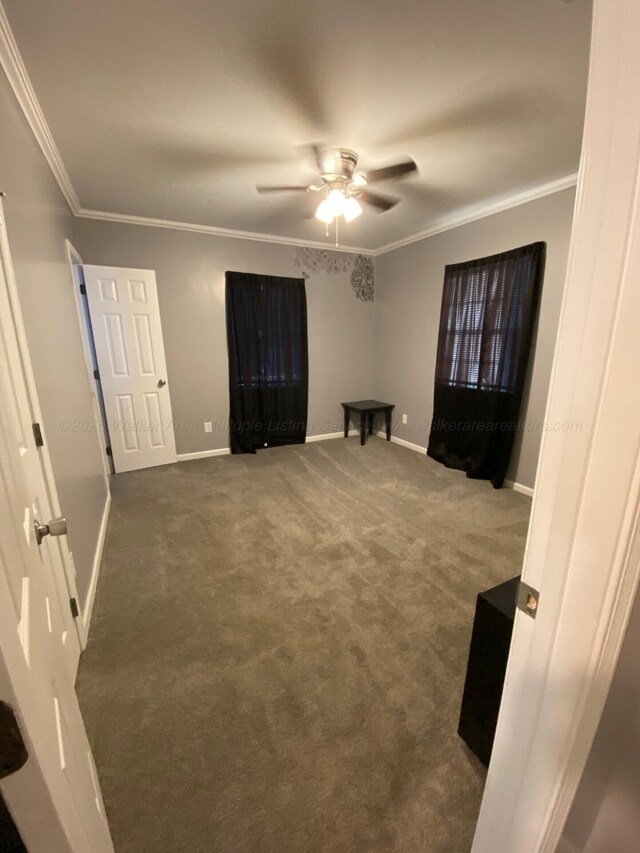 carpeted living room with ceiling fan, a raised ceiling, crown molding, and french doors