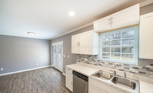 kitchen featuring sink, white cabinets, stainless steel dishwasher, and light hardwood / wood-style flooring