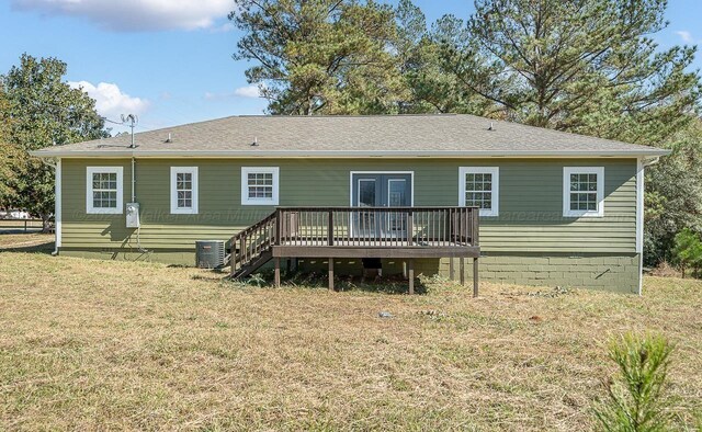 back of property featuring french doors, a yard, a deck, and cooling unit