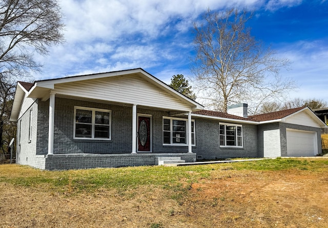 ranch-style house featuring a garage, brick siding, a chimney, and a front lawn